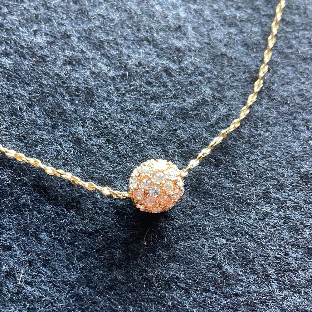 This Lia Sophia necklace is gold and 8 inches long.